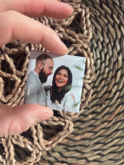 A real Magnipix wedding photo magnet held between two fingers